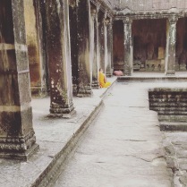 A Monk awaits prayer in Angkor Wat, Siem Reap, Cambodia